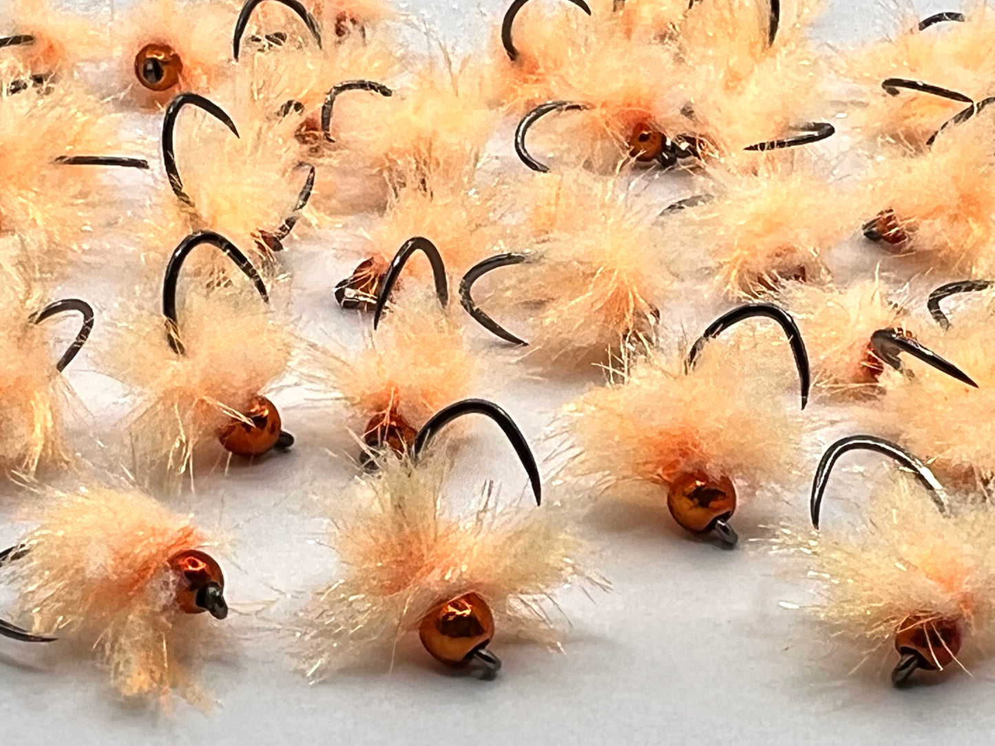Assorted apricot tungsten egg flies with barbless hooks, orange fuzzy bodies