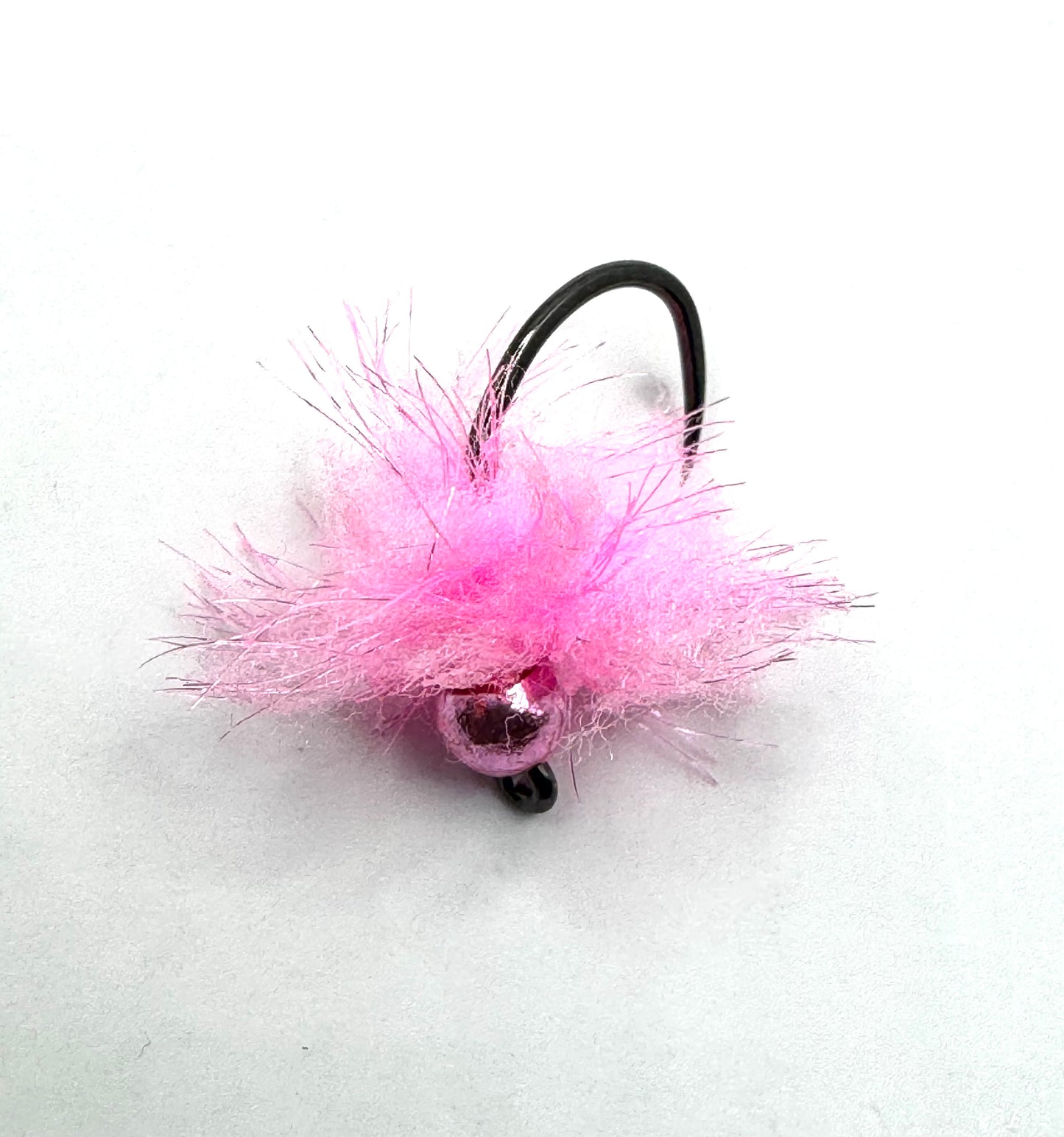 Pink fuzzy fly fishing jig with two dark bead eyes and black curved hook