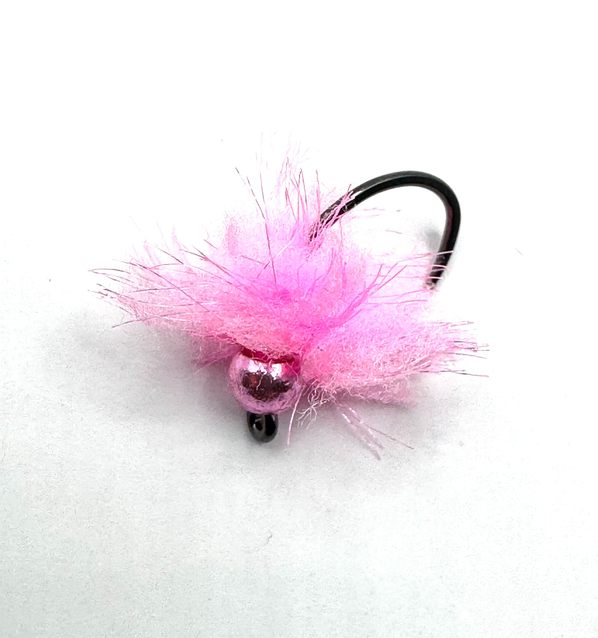 Pink fuzzy fly fishing jig with black curved hook and two dark bead eyes