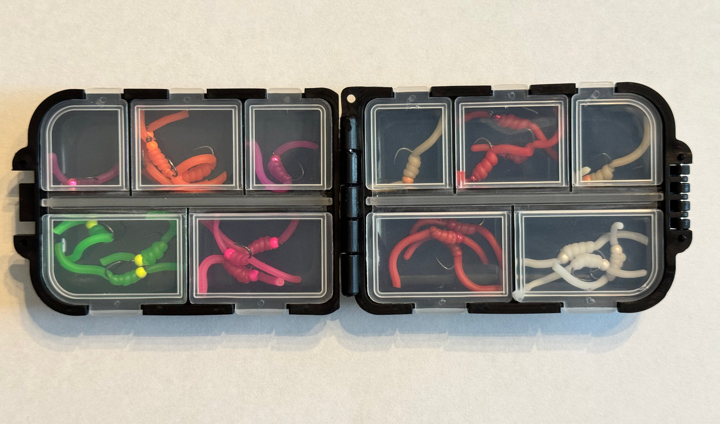 Tungsten Squirmy fly box with hinged compartments showing colorful foam bait sleeves