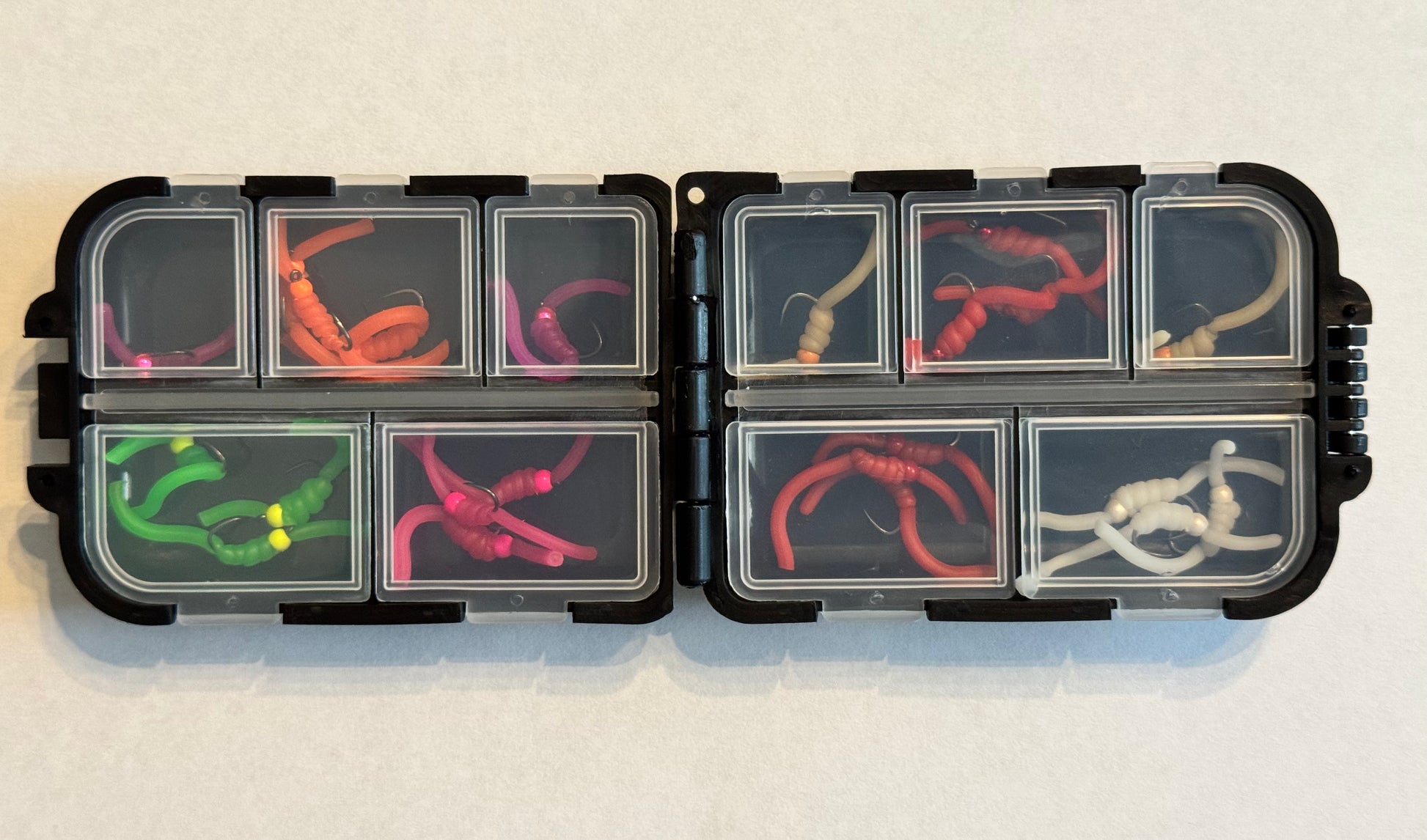 Tungsten Squirmy fly box with hinged compartments showing colorful foam bait sleeves