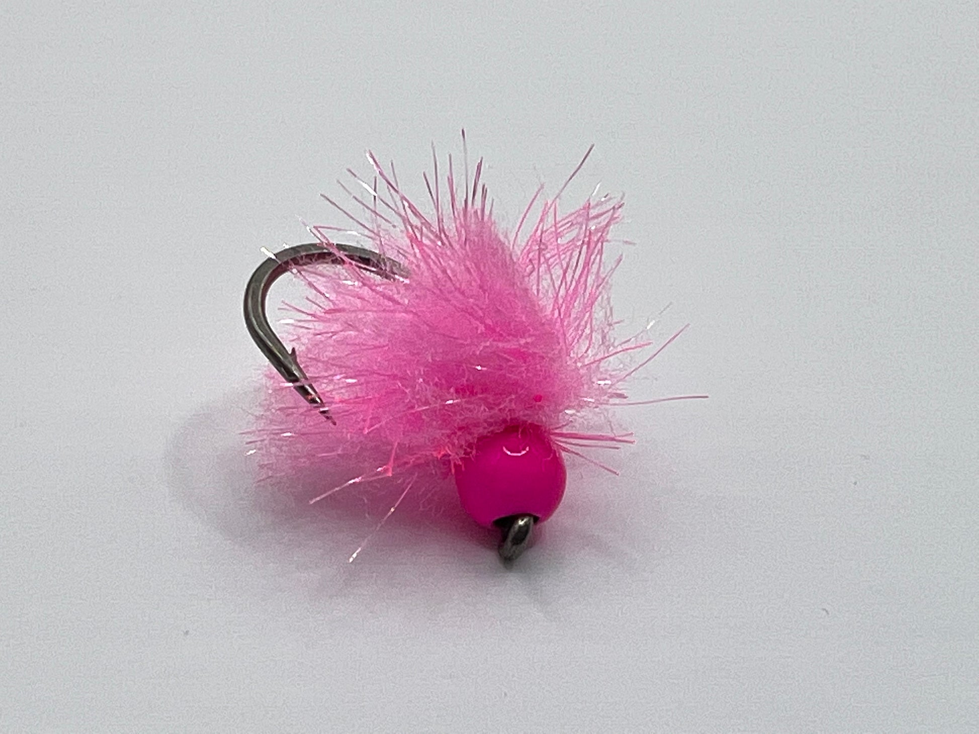 Size 12 pink tungsten egg fly with fuzzy pink body and barbed hooks