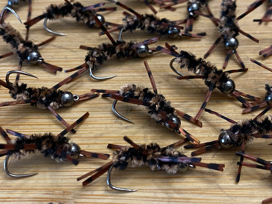 Mini Stoneflies close-up: silver bead heads, coffee-black fuzzy body, barbed hook points